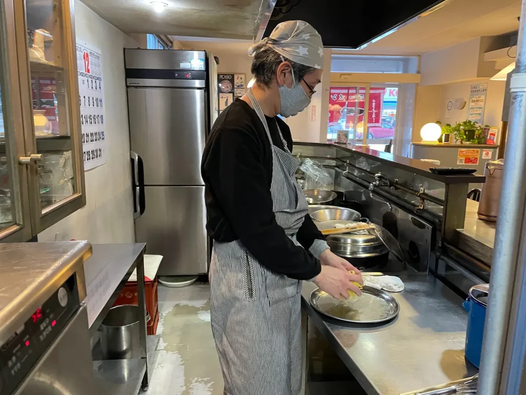 丁寧に麺をほぐす田中さん